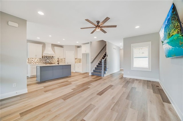 23506 E 10th St S, Independence, MO 64056 - unfurnished living room featuring stairway, ceiling fan, light wood-style flooring, and recessed lighting
