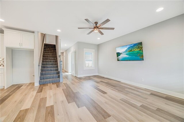 23506 E 10th St S, Independence, MO 64056 - unfurnished living room featuring a ceiling fan, stairs, light wood-type flooring, and recessed lighting