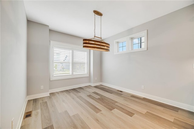 23506 E 10th St S, Independence, MO 64056 - unfurnished dining area featuring light wood-style flooring and baseboards