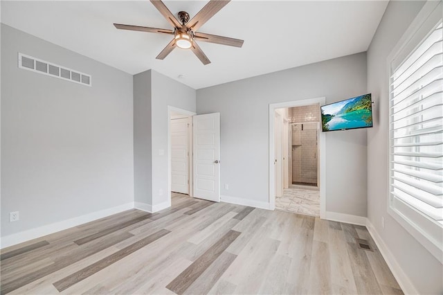 23506 E 10th St S, Independence, MO 64056 - unfurnished bedroom with light wood-type flooring, ensuite bath, and a ceiling fan