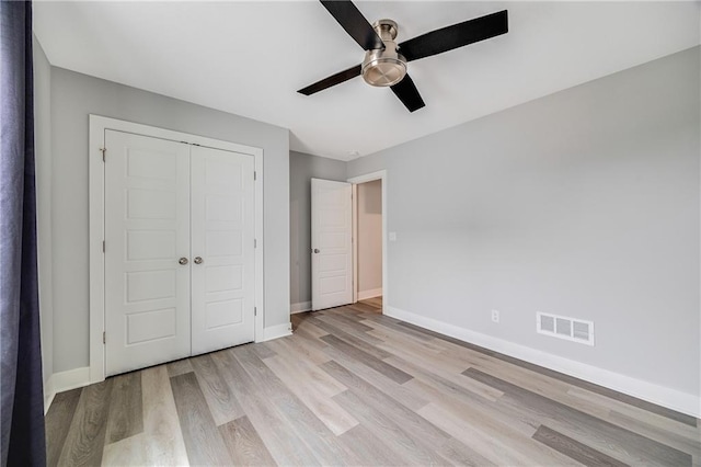 23506 E 10th St S, Independence, MO 64056 - unfurnished bedroom with light wood finished floors, a closet, and ceiling fan