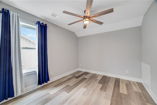 23506 E 10th St S, Independence, MO 64056 - spare room featuring ceiling fan, wood finished floors, and vaulted ceiling