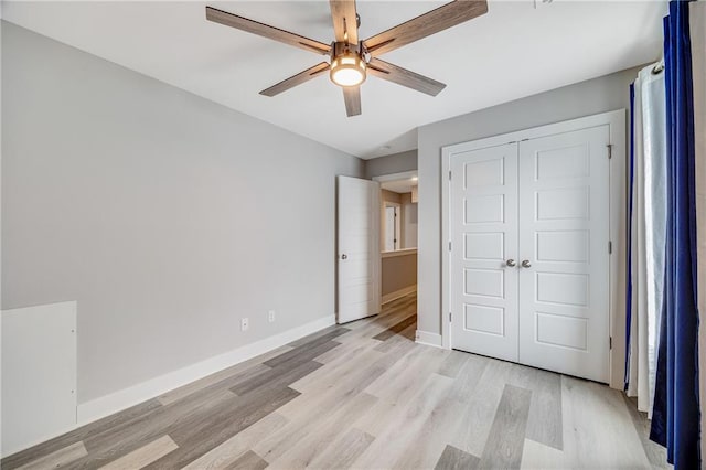 23506 E 10th St S, Independence, MO 64056 - unfurnished bedroom featuring light wood-type flooring, a closet, and ceiling fan