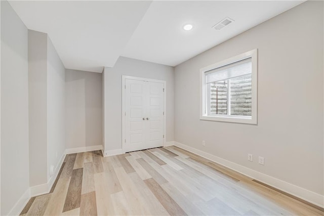 23506 E 10th St S, Independence, MO 64056 - unfurnished bedroom with light wood finished floors, a closet, and recessed lighting