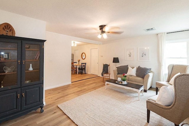 319 E 12th St, Ottawa, KS 66067 - living room with light wood-style floors and a ceiling fan