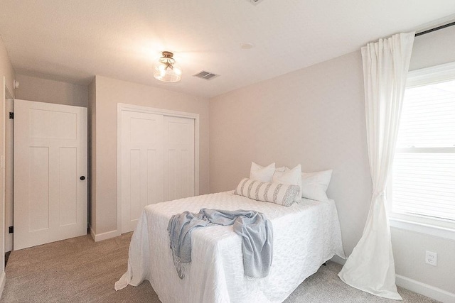 319 E 12th St, Ottawa, KS 66067 - bedroom featuring light colored carpet and a closet