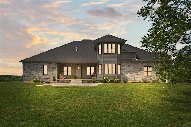 6417 County Road 10508th Rd, Rich Hill, MO 64779 - back of property at dusk with a yard, a patio, and roof with shingles