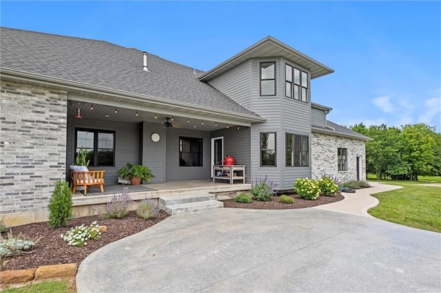 6417 County Road 10508th Rd, Rich Hill, MO 64779 - view of front of home featuring a ceiling fan, roof with shingles, and a patio area