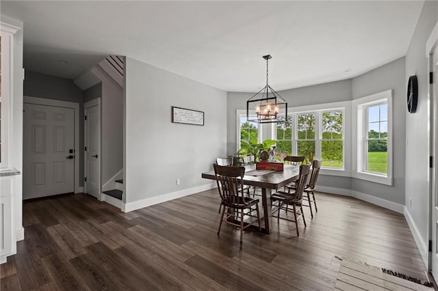 6417 County Road 10508th Rd, Rich Hill, MO 64779 - dining space featuring dark wood finished floors, a chandelier, and stairway