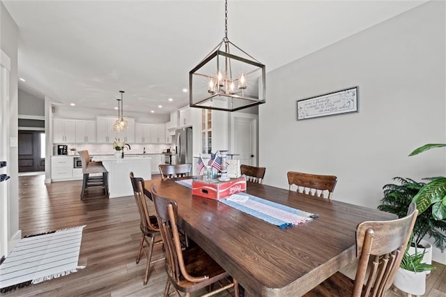 6417 County Road 10508th Rd, Rich Hill, MO 64779 - dining space with a chandelier, recessed lighting, and wood finished floors