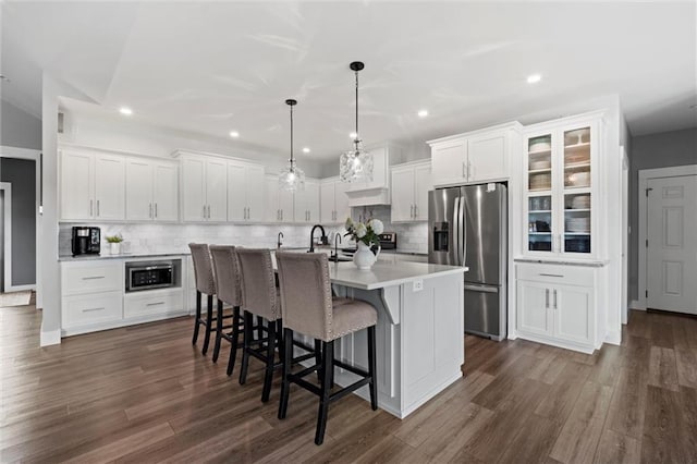 6417 County Road 10508th Rd, Rich Hill, MO 64779 - kitchen featuring stainless steel appliances, light countertops, white cabinetry, a breakfast bar area, and a kitchen island with sink