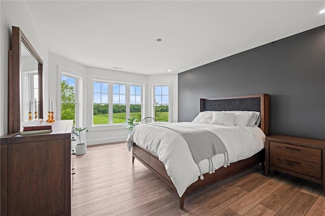 6417 County Road 10508th Rd, Rich Hill, MO 64779 - bedroom with multiple windows, wood finished floors, and recessed lighting