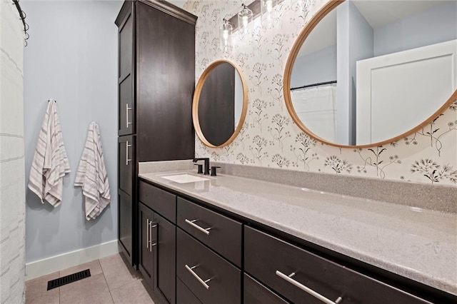 6417 County Road 10508th Rd, Rich Hill, MO 64779 - bathroom with wallpapered walls, vanity, and tile patterned flooring