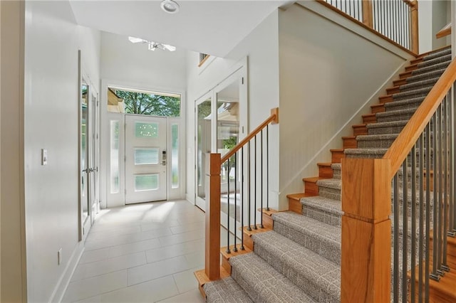 6112 N Mattox Rd, Kansas City, MO 64151 - tiled entrance foyer with stairs, a chandelier, and a towering ceiling