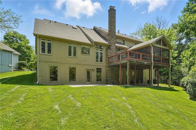 6112 N Mattox Rd, Kansas City, MO 64151 - rear view of house with a chimney, a lawn, a deck, a patio, and roof with shingles