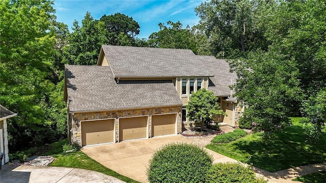 6112 N Mattox Rd, Kansas City, MO 64151 - view of front of home with stone siding, roof with shingles, a garage, and driveway