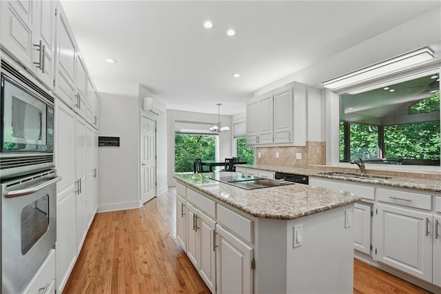 6112 N Mattox Rd, Kansas City, MO 64151 - kitchen featuring stainless steel appliances, a kitchen island, white cabinetry, and recessed lighting
