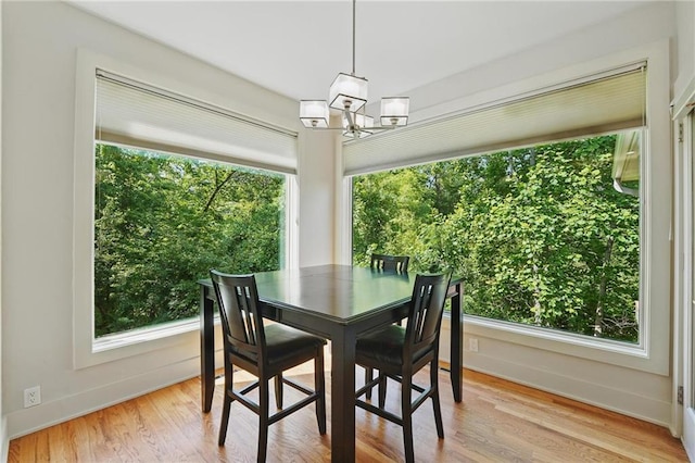 6112 N Mattox Rd, Kansas City, MO 64151 - dining space with a chandelier and light wood-type flooring