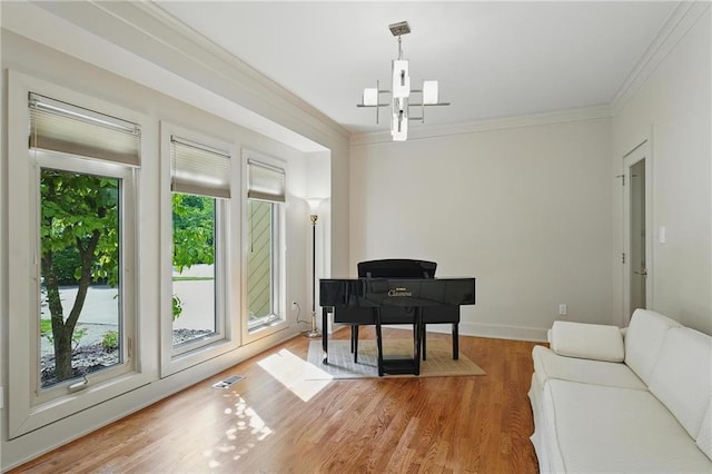 6112 N Mattox Rd, Kansas City, MO 64151 - sitting room featuring wood finished floors, crown molding, and a chandelier