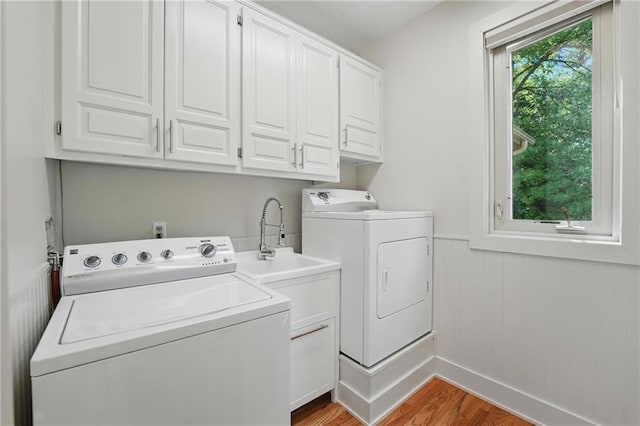 6112 N Mattox Rd, Kansas City, MO 64151 - laundry room with independent washer and dryer, cabinet space, wood finished floors, and wainscoting