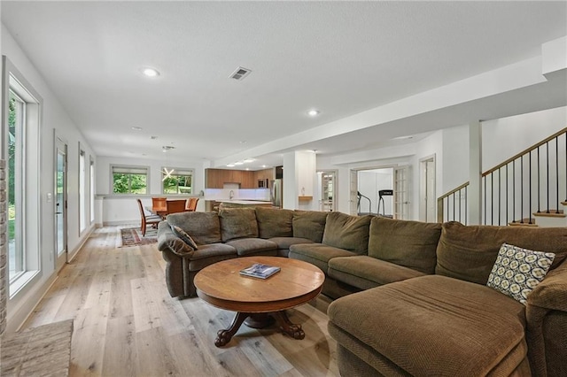 6112 N Mattox Rd, Kansas City, MO 64151 - living room with light wood-style flooring, recessed lighting, and stairway