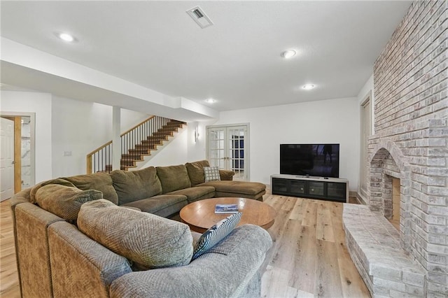 6112 N Mattox Rd, Kansas City, MO 64151 - living area with light wood finished floors, stairs, a fireplace, and recessed lighting