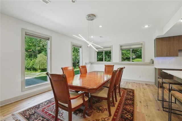 6112 N Mattox Rd, Kansas City, MO 64151 - dining room featuring plenty of natural light, light wood-style floors, a chandelier, and recessed lighting