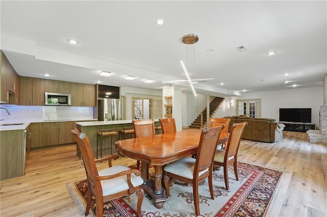 6112 N Mattox Rd, Kansas City, MO 64151 - dining room with stairs, light wood finished floors, and recessed lighting