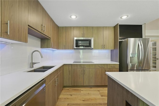 6112 N Mattox Rd, Kansas City, MO 64151 - kitchen with stainless steel appliances, light countertops, decorative backsplash, light wood-type flooring, and recessed lighting