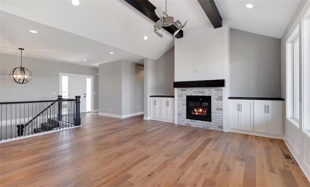 6045 Apache Dr, Shawnee, KS 66226 - unfurnished living room featuring light wood-style flooring, a chandelier, a fireplace, and recessed lighting