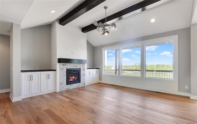 6045 Apache Dr, Shawnee, KS 66226 - unfurnished living room with light wood-style flooring and a brick fireplace