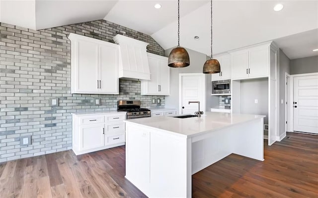 6045 Apache Dr, Shawnee, KS 66226 - kitchen featuring appliances with stainless steel finishes, lofted ceiling, dark wood-type flooring, white cabinets, and recessed lighting