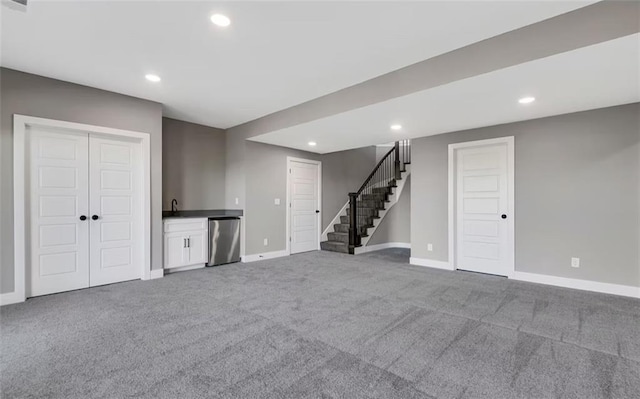 6045 Apache Dr, Shawnee, KS 66226 - basement featuring carpet flooring, stairs, recessed lighting, and bar