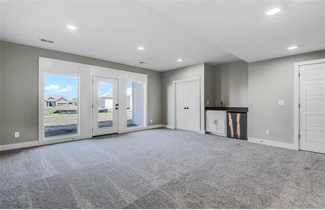 6045 Apache Dr, Shawnee, KS 66226 - unfurnished living room featuring carpet flooring, recessed lighting, and french doors