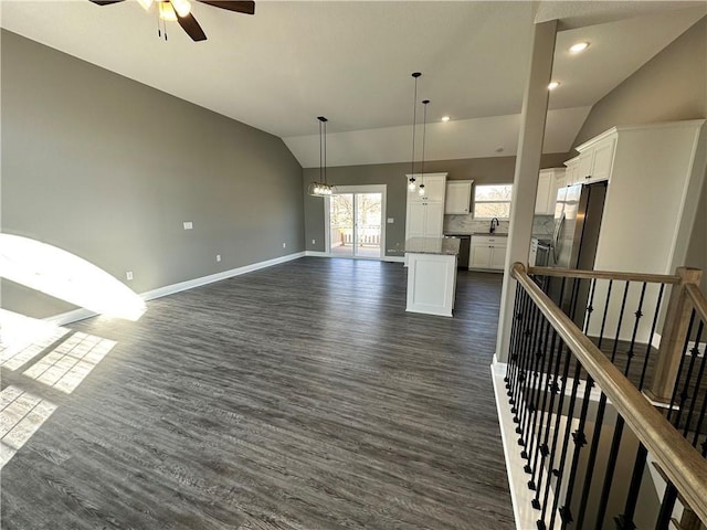 318 NE 51st Rd, Warrensburg, MO 64093 - unfurnished living room featuring vaulted ceiling, dark wood finished floors, and a ceiling fan