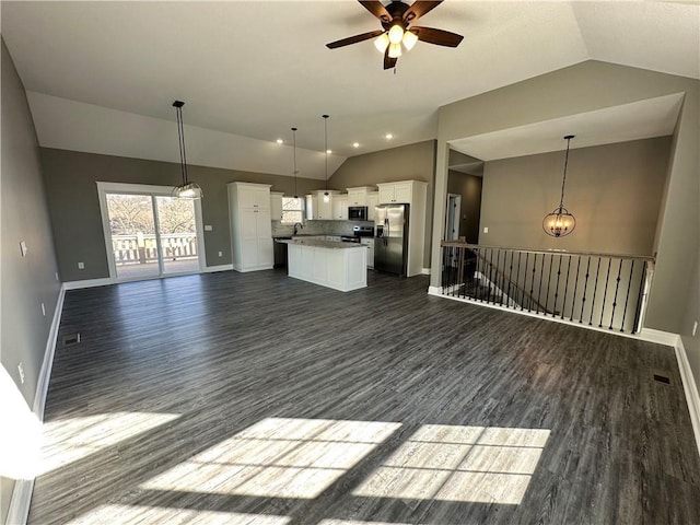 318 NE 51st Rd, Warrensburg, MO 64093 - kitchen featuring vaulted ceiling, open floor plan, appliances with stainless steel finishes, ceiling fan, and white cabinets