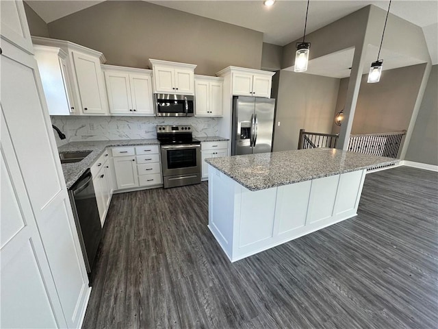318 NE 51st Rd, Warrensburg, MO 64093 - kitchen featuring stainless steel appliances, dark wood finished floors, a kitchen island, decorative backsplash, and white cabinetry