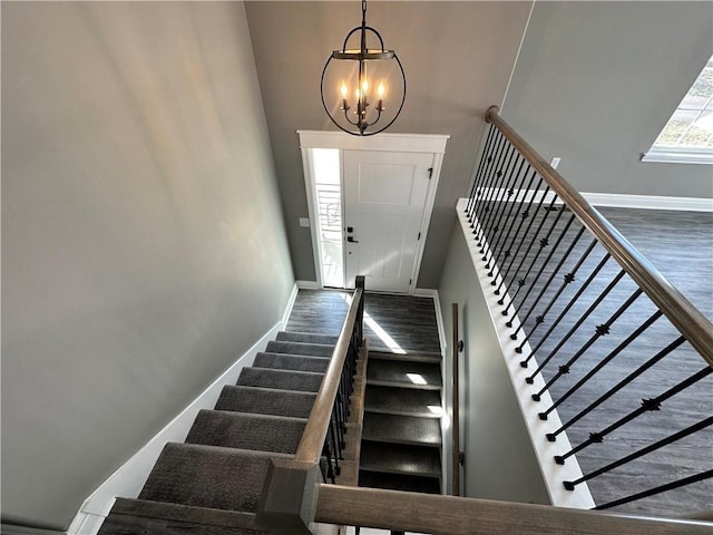 318 NE 51st Rd, Warrensburg, MO 64093 - stairway with wood finished floors, a chandelier, and a high ceiling