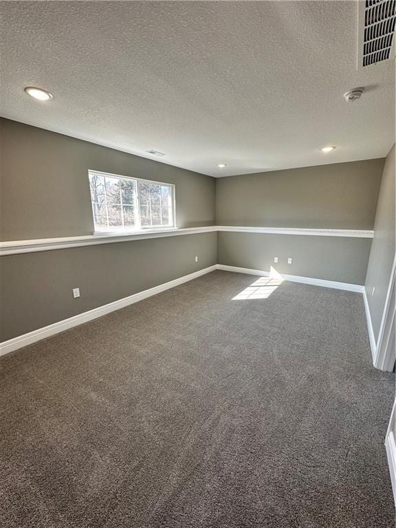 318 NE 51st Rd, Warrensburg, MO 64093 - empty room with a textured ceiling, dark carpet, and recessed lighting