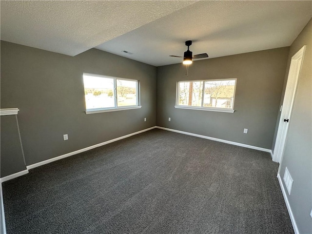 318 NE 51st Rd, Warrensburg, MO 64093 - empty room featuring a ceiling fan, dark carpet, and a textured ceiling