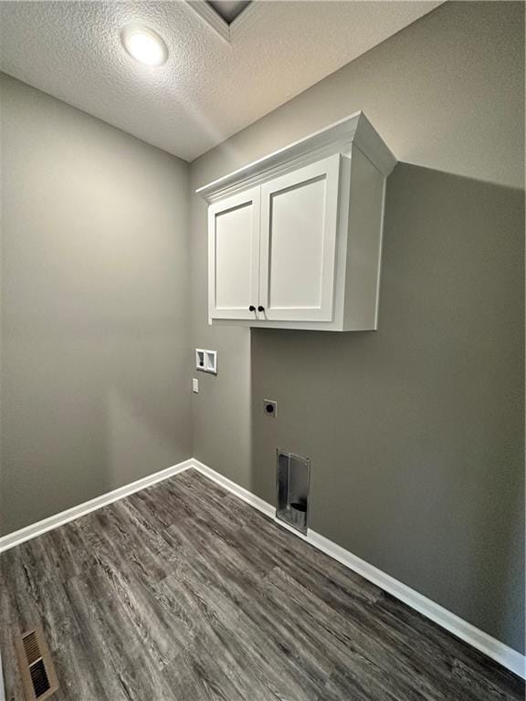 318 NE 51st Rd, Warrensburg, MO 64093 - laundry area with cabinet space, dark wood-style floors, electric dryer hookup, a textured ceiling, and hookup for a washing machine