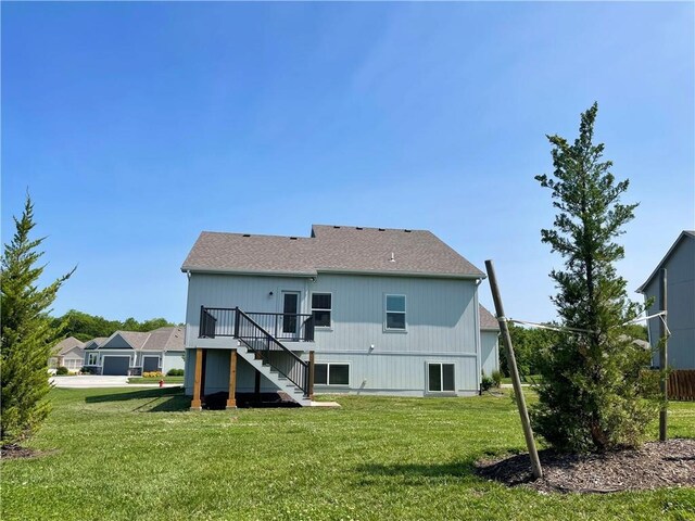 1116 SW Whispering Willow Way, Blue Springs, MO 64064 - rear view of house featuring stairs, a wooden deck, a lawn, and roof with shingles
