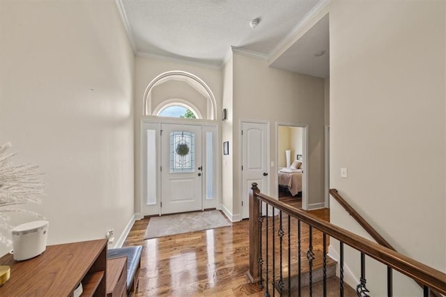 18783 W 165th St, Olathe, KS 66062 - entryway with ornamental molding, wood finished floors, and a textured ceiling