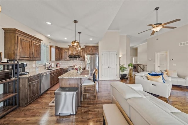 18783 W 165th St, Olathe, KS 66062 - kitchen featuring stainless steel appliances, open floor plan, dark wood-type flooring, backsplash, and recessed lighting