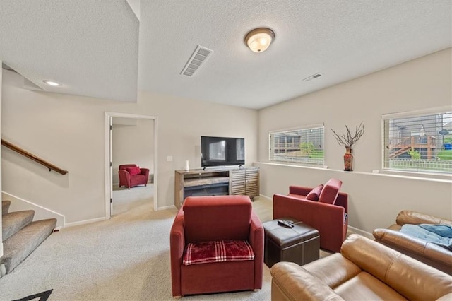 18783 W 165th St, Olathe, KS 66062 - living room with carpet floors, stairway, and a textured ceiling