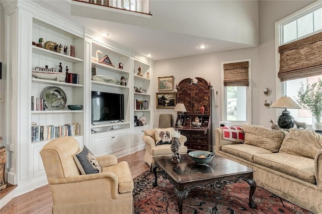 11 Dockside Dr, Lake Tapawingo, MO 64015 - living area featuring light wood-type flooring, a towering ceiling, and built in features