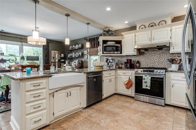 11 Dockside Dr, Lake Tapawingo, MO 64015 - kitchen with stainless steel appliances, under cabinet range hood, a peninsula, dark stone counters, and tasteful backsplash