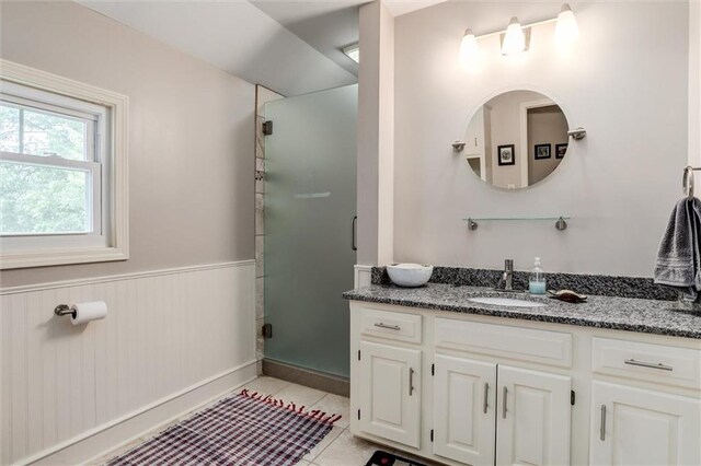 11 Dockside Dr, Lake Tapawingo, MO 64015 - bathroom featuring vanity, a wainscoted wall, a shower stall, and tile patterned flooring