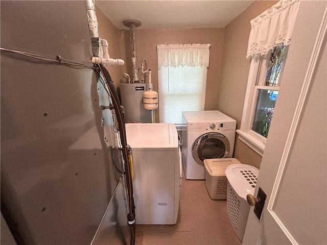 1047 N Lynn St, Nevada, MO 64772 - laundry area featuring water heater and washer and clothes dryer