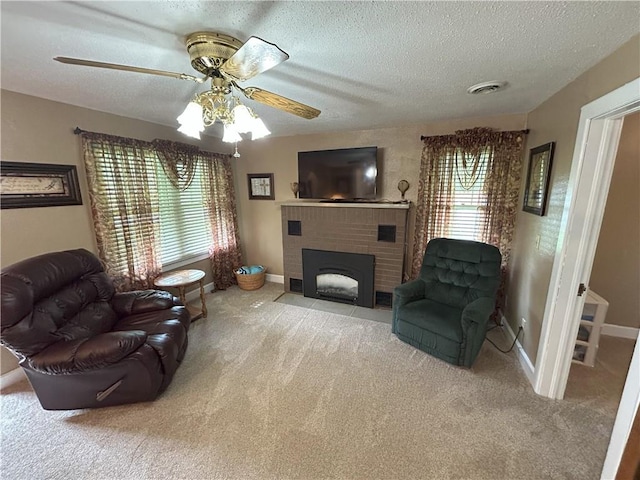 1047 N Lynn St, Nevada, MO 64772 - carpeted living room with ceiling fan, a textured ceiling, and a fireplace
